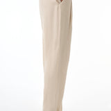 Beige pants worn by a woman on a white background