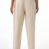 Beige pants worn by a woman on a white background