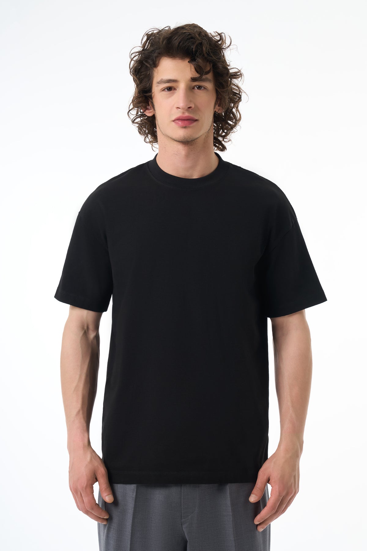 Man wearing a black t-shirt on a white background