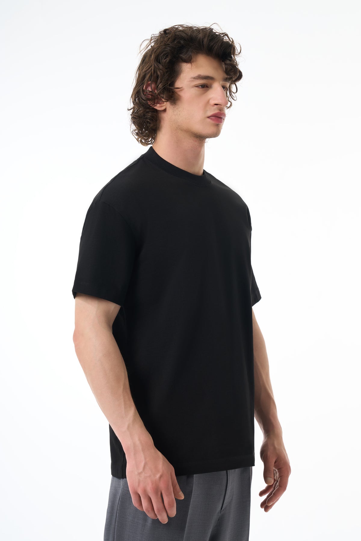 Man wearing a black t-shirt on a white background