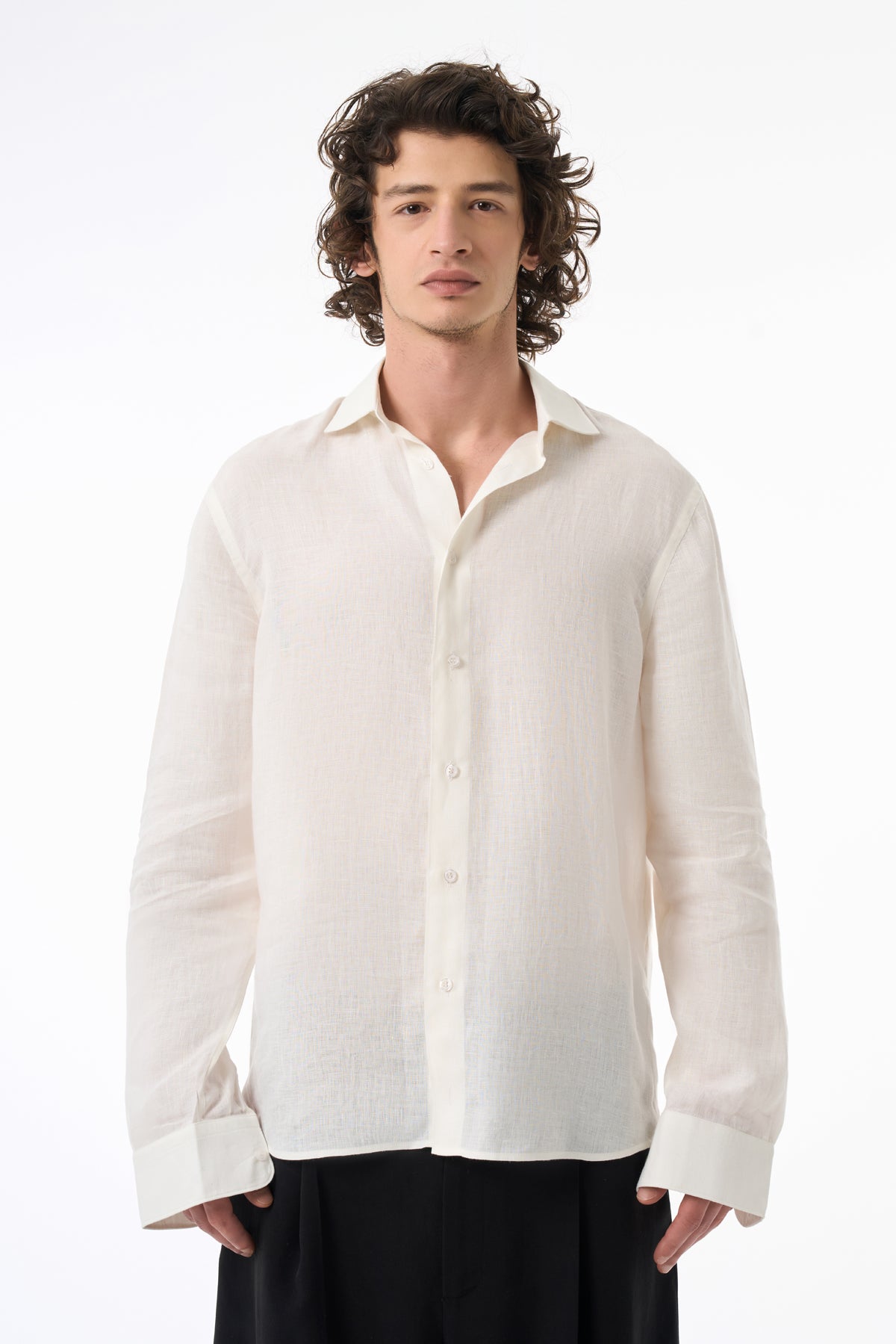 Man wearing a white linen shirt on a white background